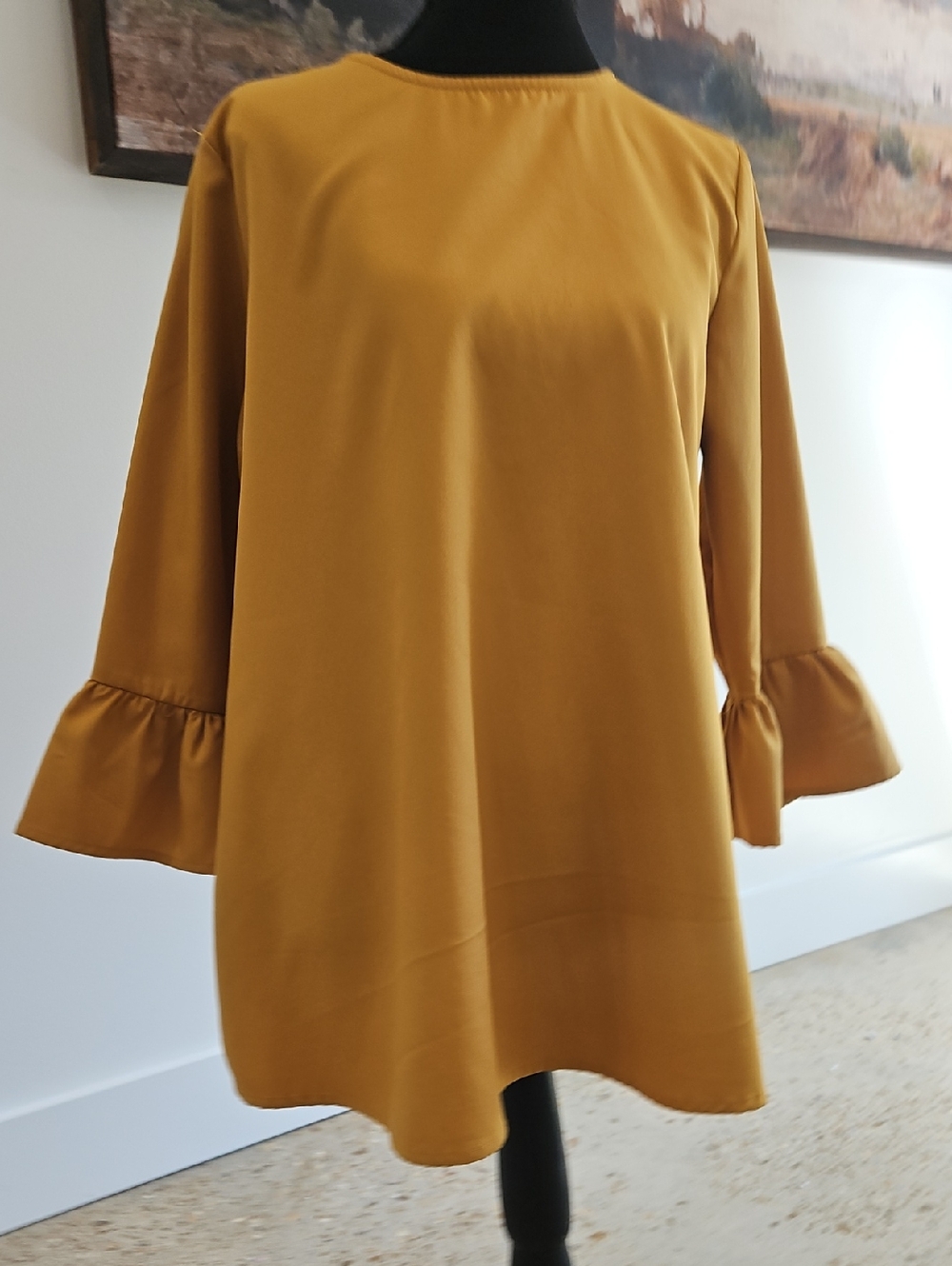 a dip of DARLING Mustard Ruffle-Sleeve Tunic Top. Size M. Black Spec On Front